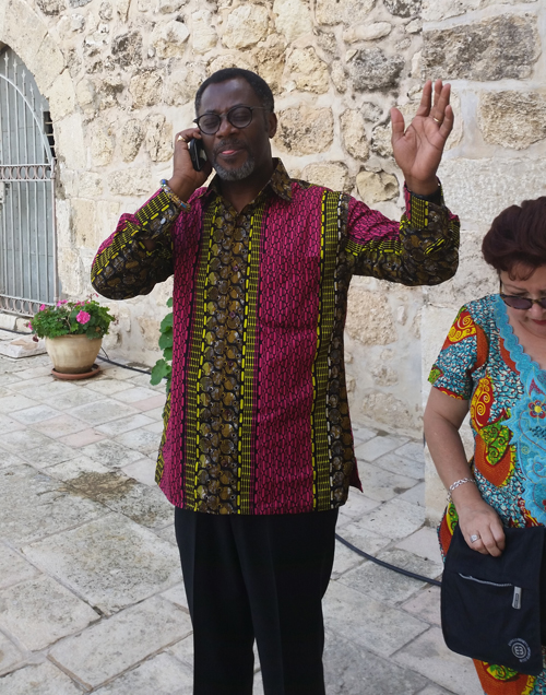 Dr. Kingsley Fletcher praying on the phone for the Ethiopian community in Jerusalem